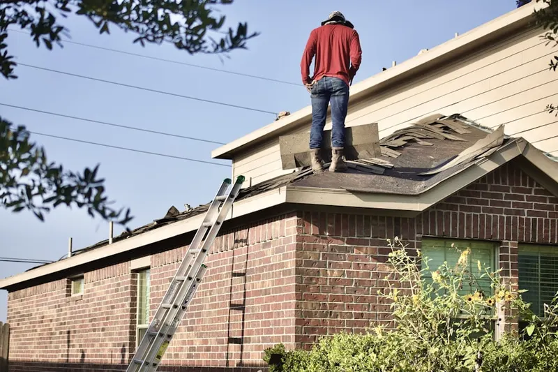 Professional roofer working on a residential roof in West Anaheim
